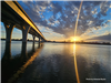 Bridge crossing the Missouri River in front of sunset. 