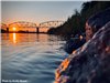 A picture of a rock beside the Missouri River at sunset. 