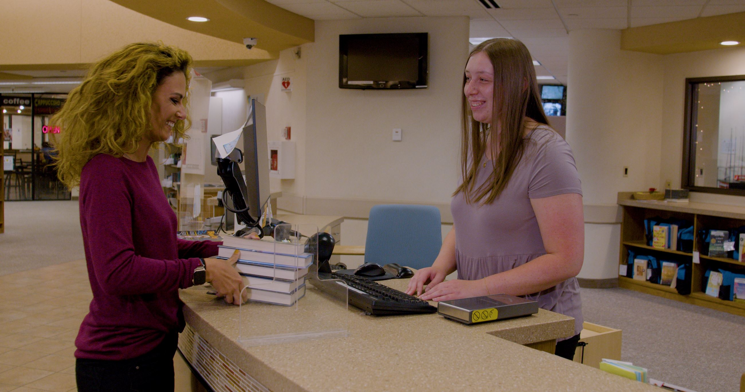 Patron Checking Out Books