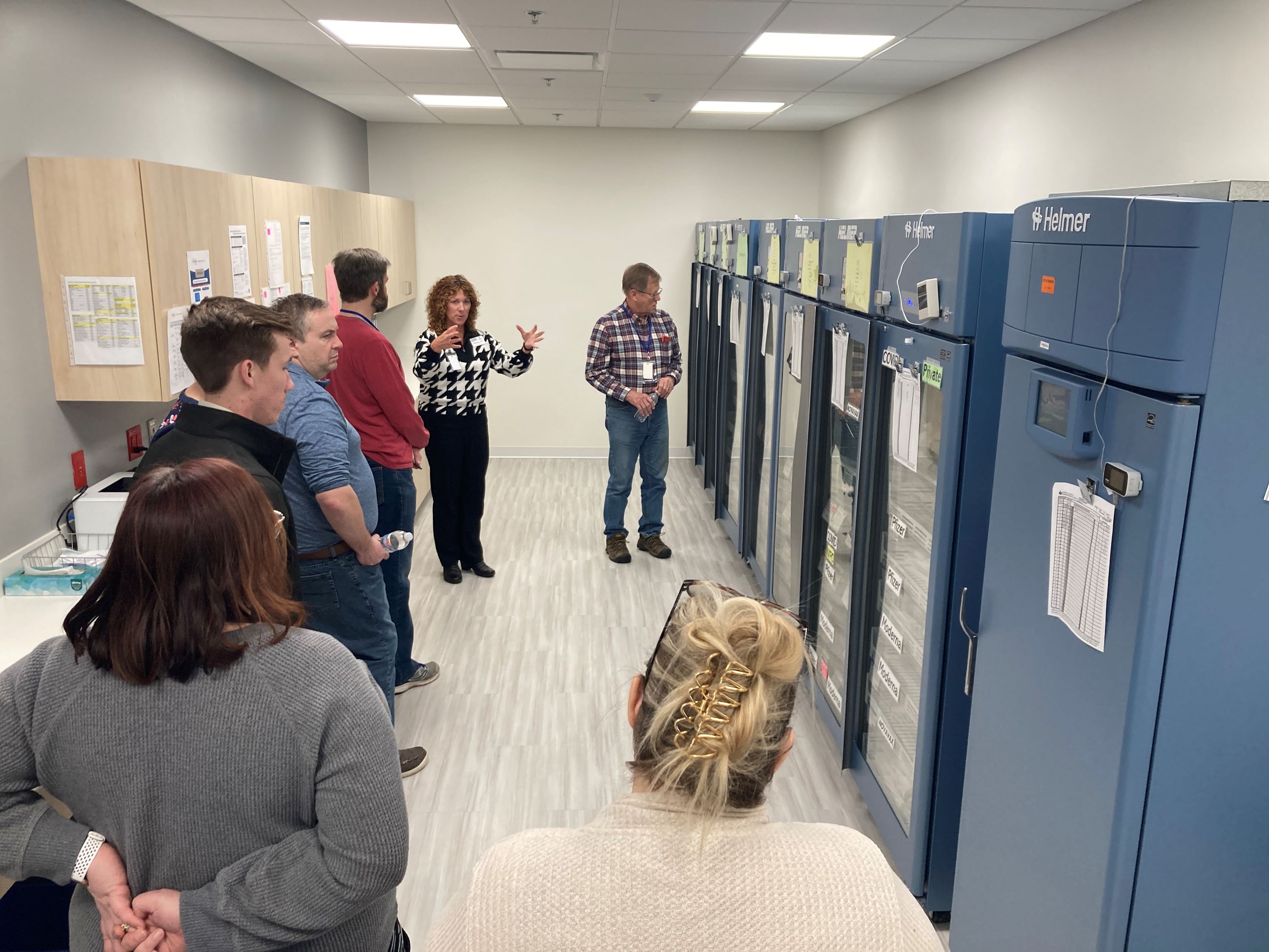 Nursing Manager Theresa Schmidt shows Citizen Academy vaccine refrigerators. 