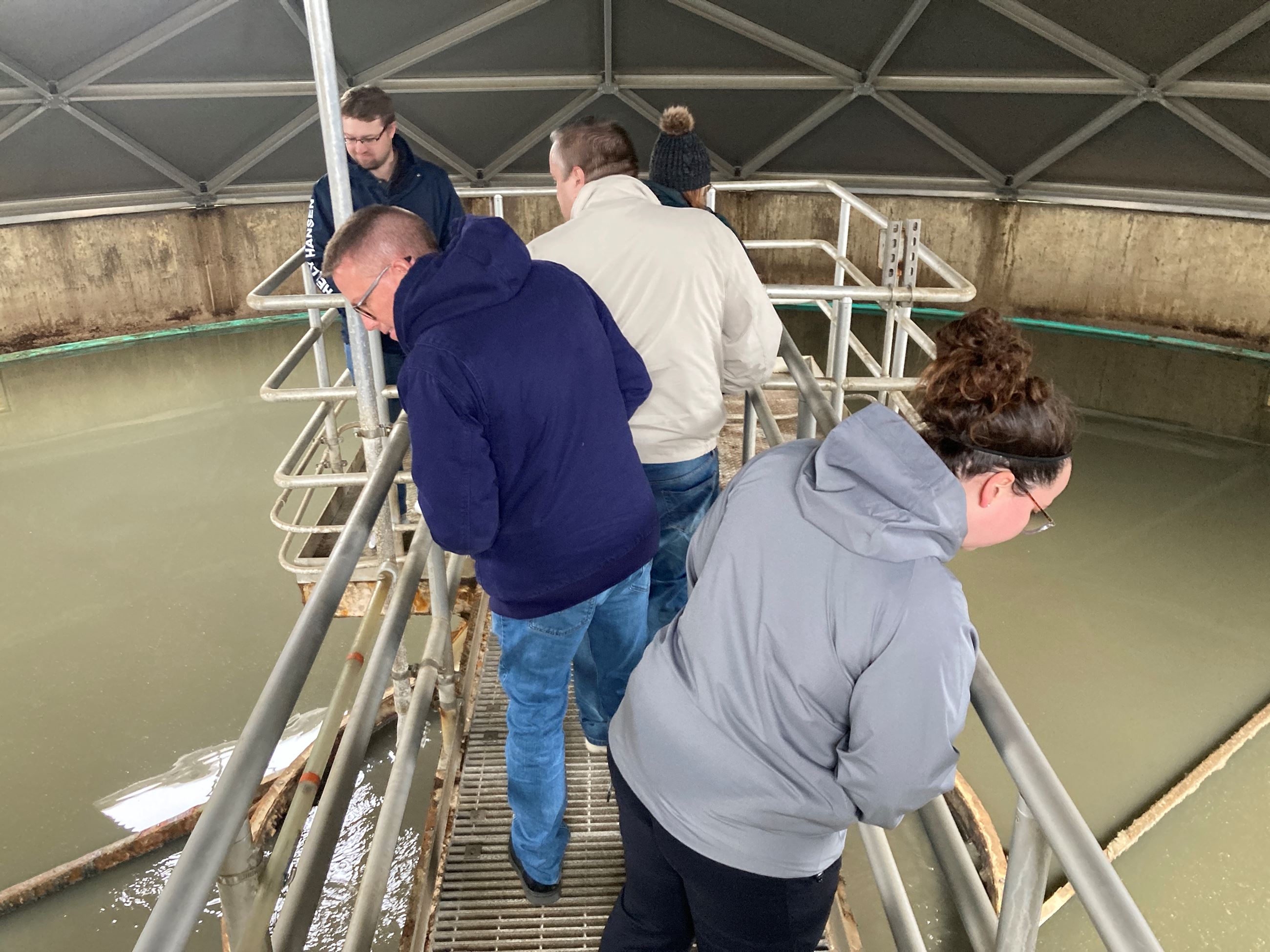 Attendees walk onto a platform at the wastewater treatment plant. 