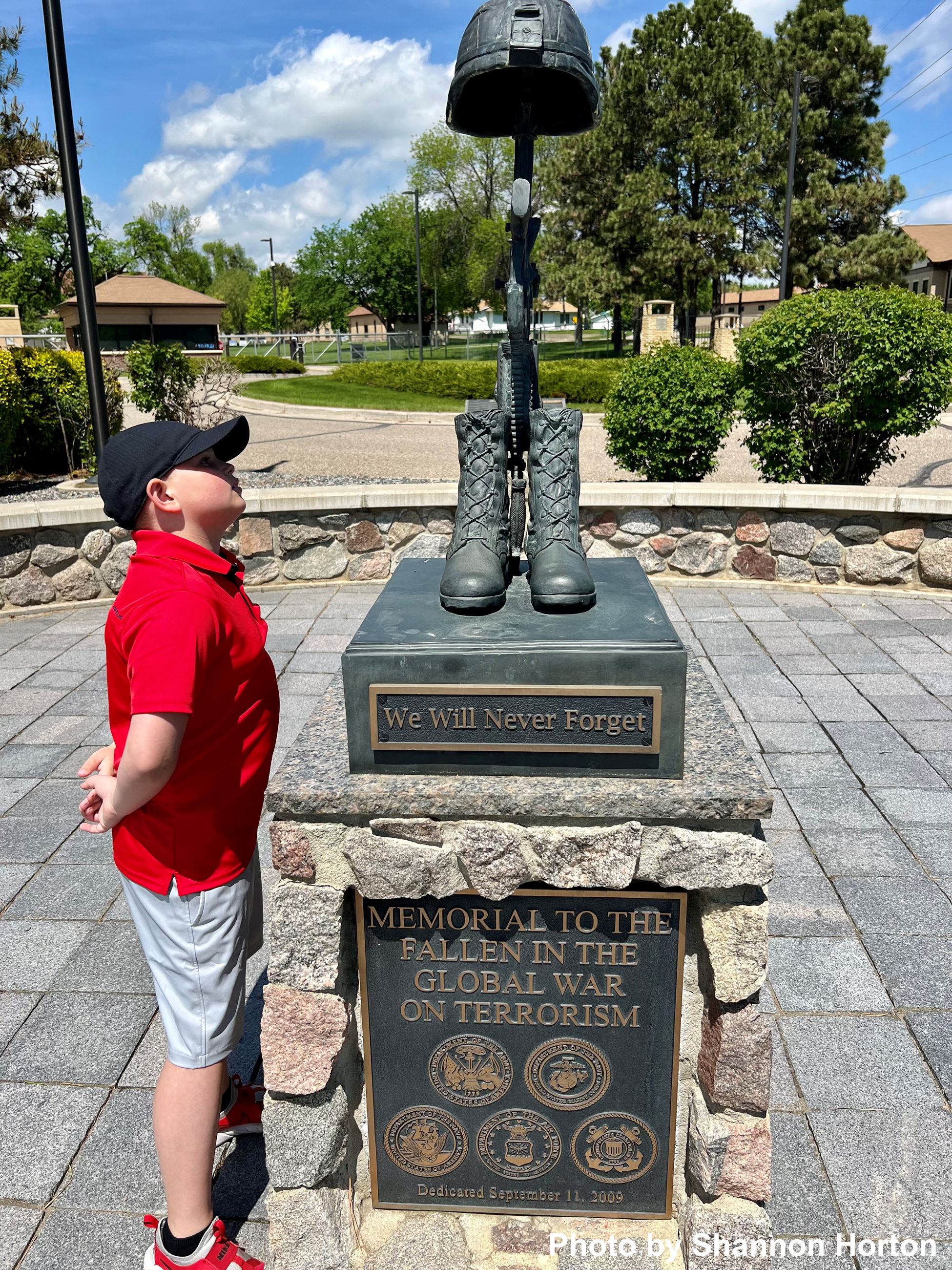 A boy looking at a statue. 