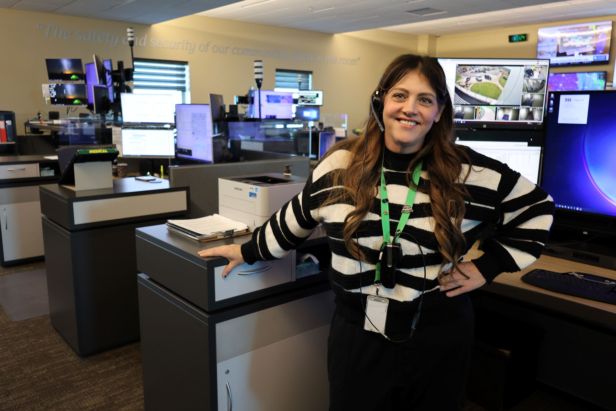 A woman is seated in front of a computer. 