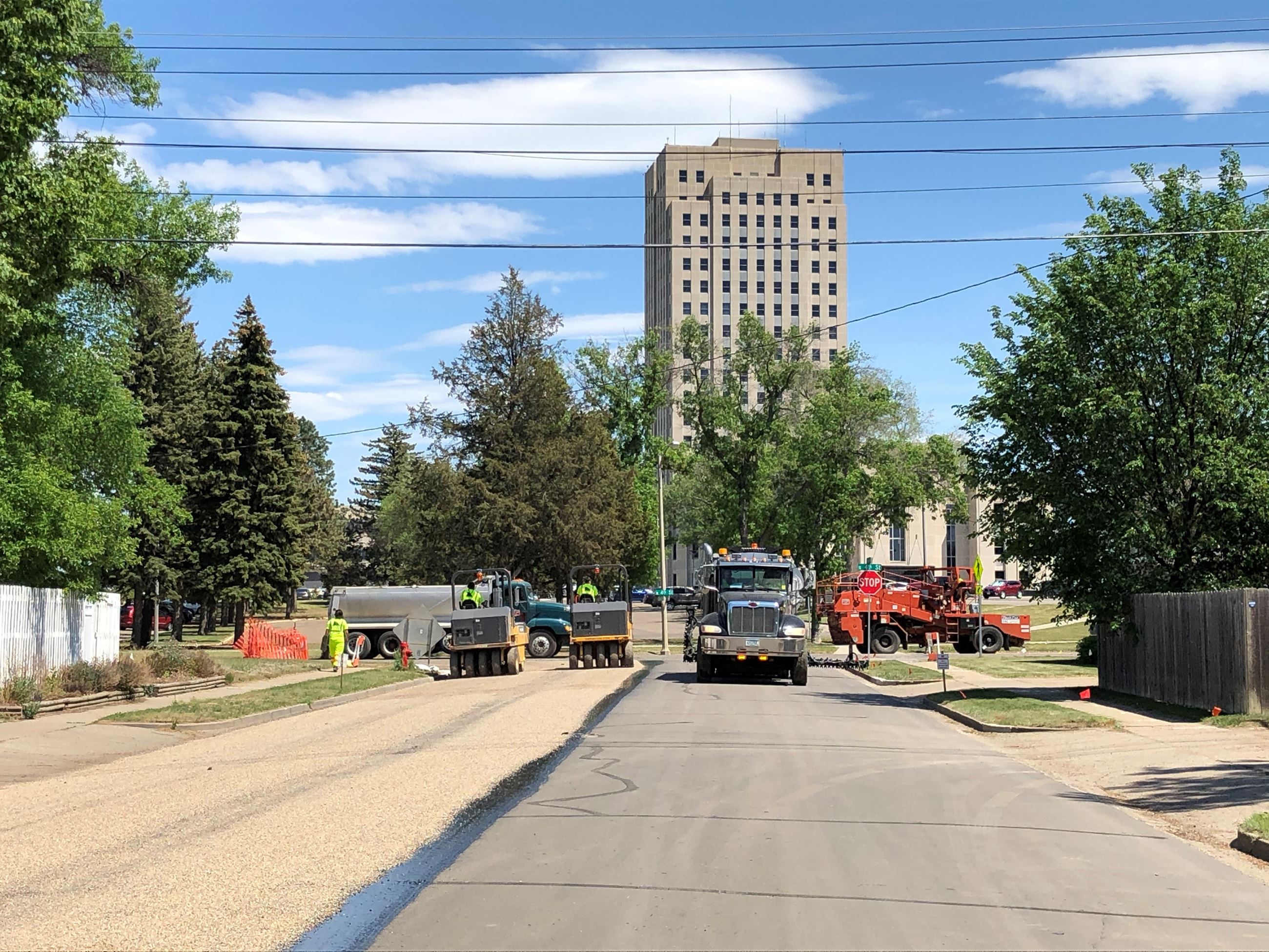 Workers pave a street in front of the State Capitol grounds in Bismarck. 