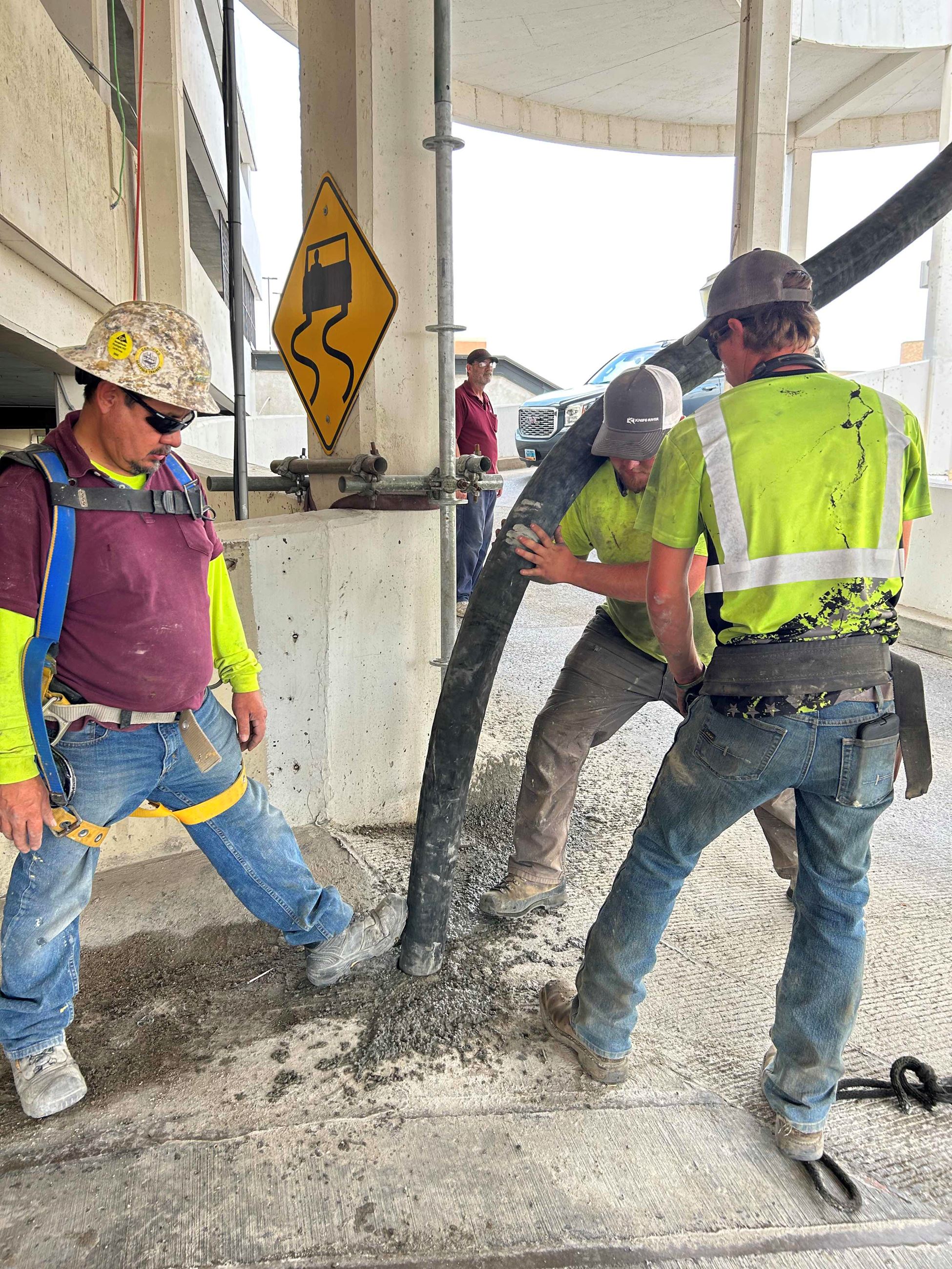 Construction workers place concrete in pre-drilled holes in the Parkade during improvements in 2023.